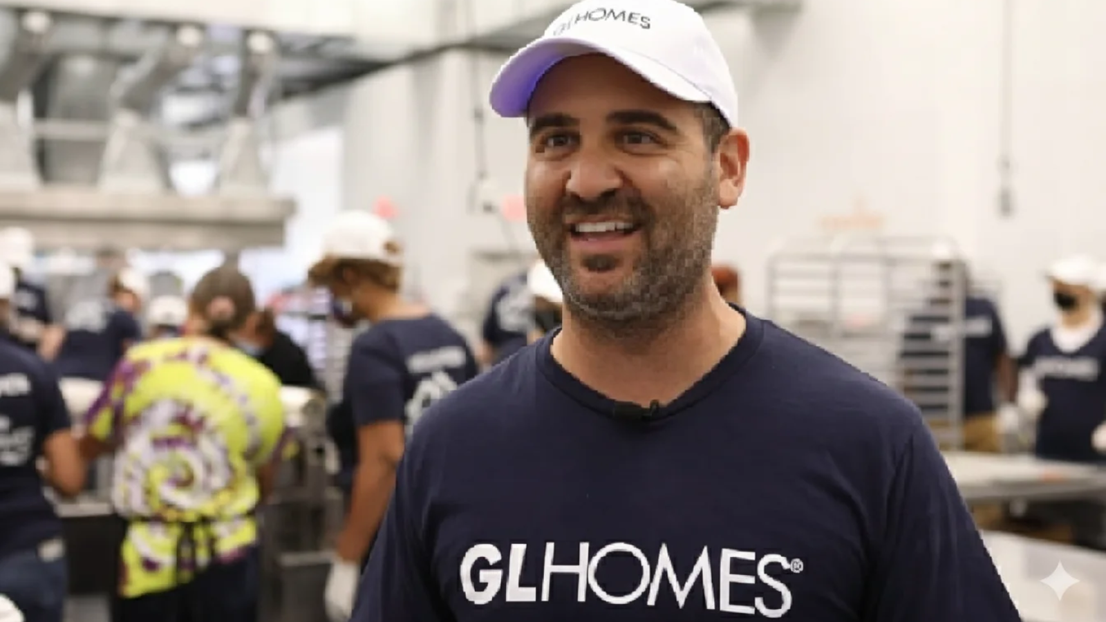 Misha Ezratti standing in a community setting representing misha ezratti net worth.